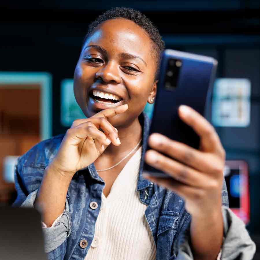 black-woman-happily-using-mobile-device